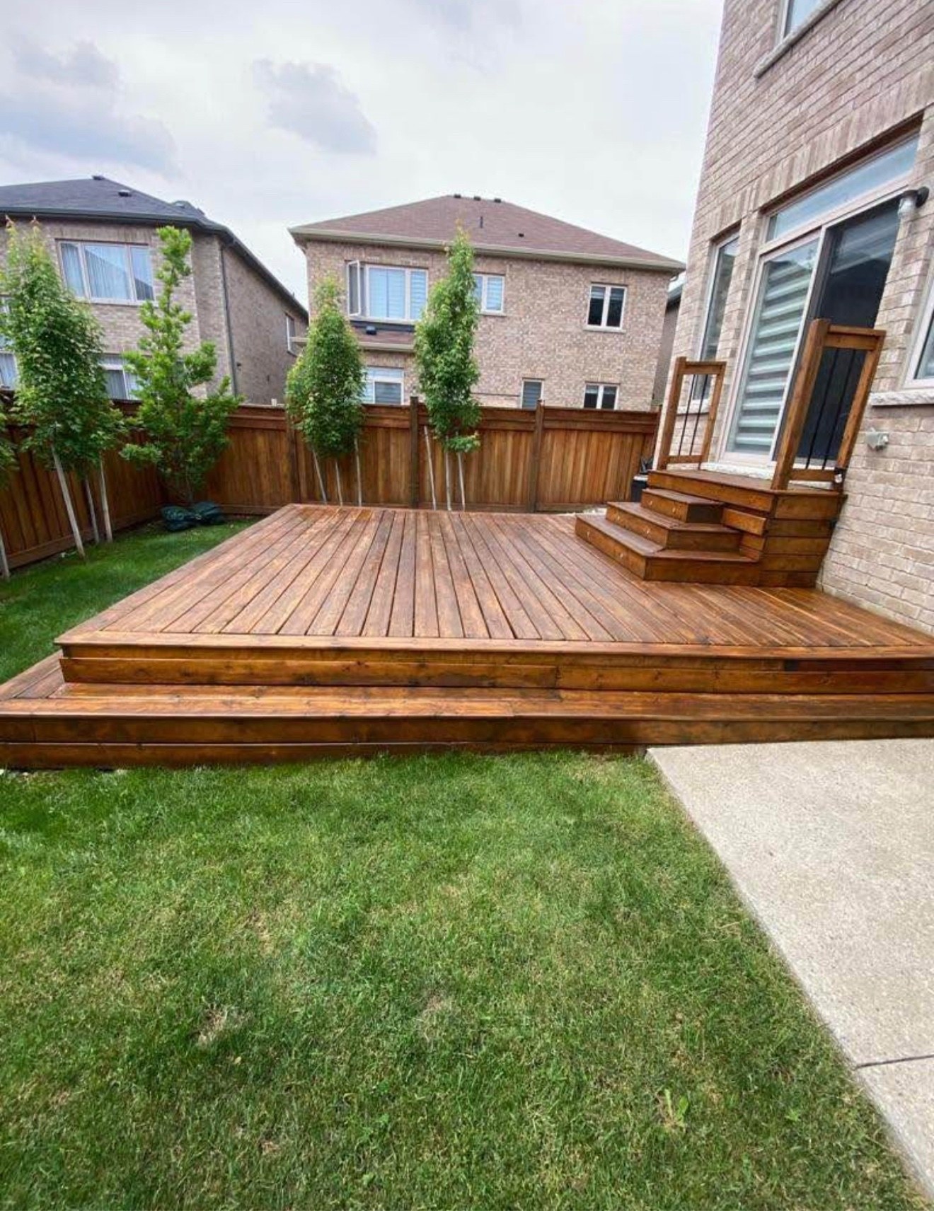 Stained wood deck beside a GTA home