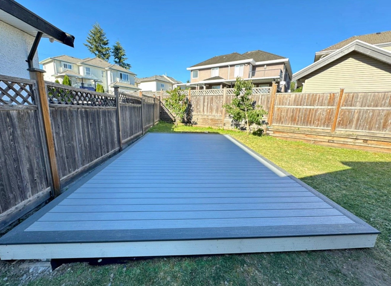 Grey composite deck beside an outdoor pool