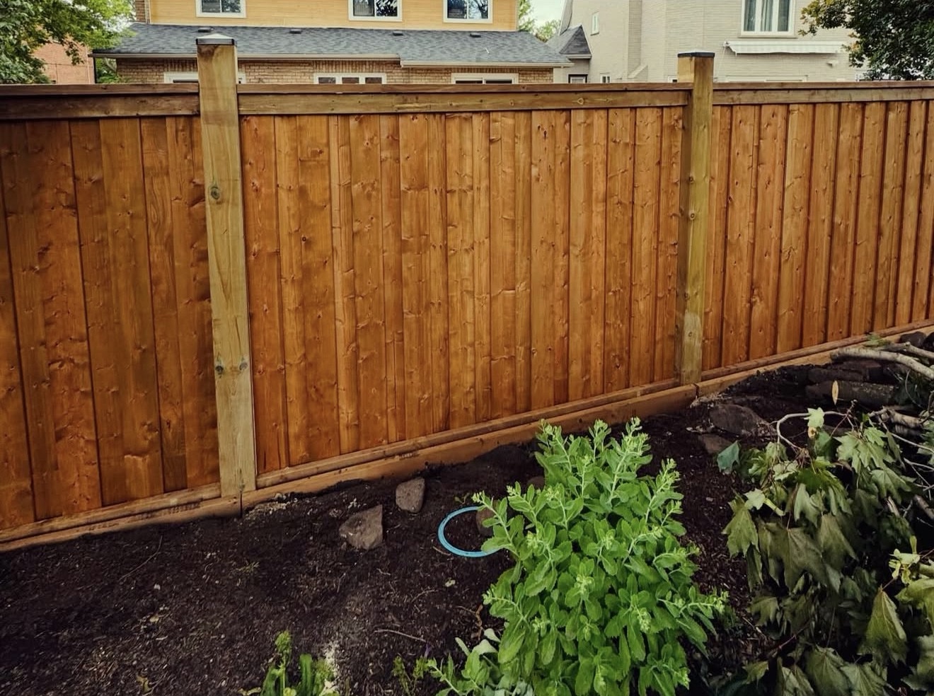 Full-height board-on-board privacy fence with top cap rails