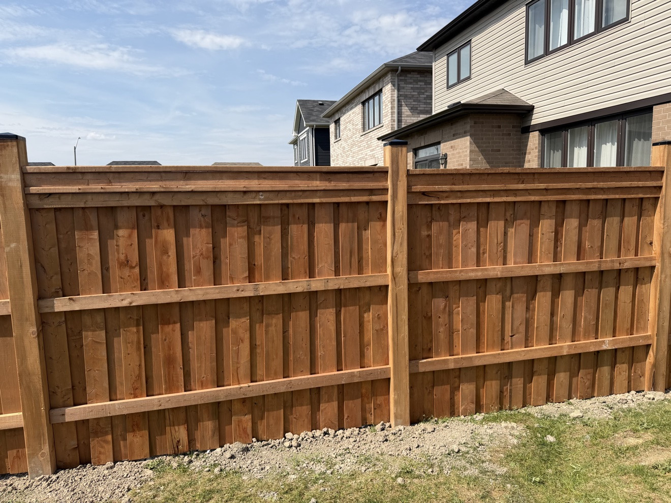 Pressure-treated wood privacy fence